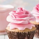 Cupcakes with sweet rose flowers and a cup of tee